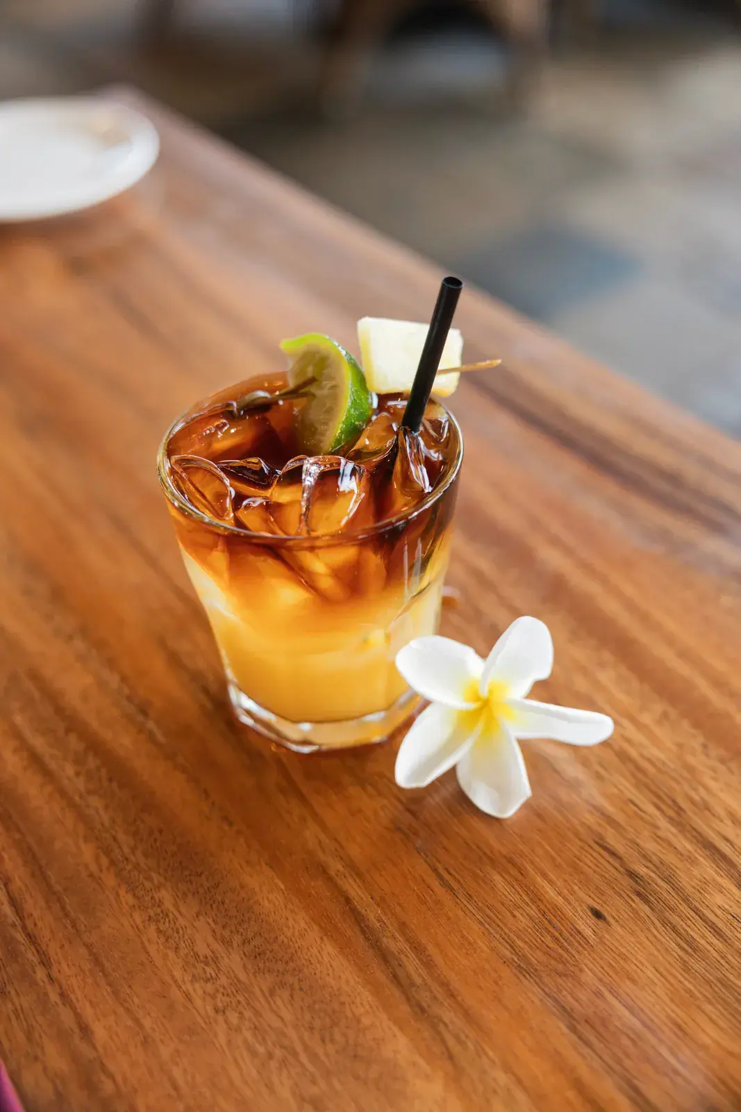 Kona Inn world-famous Mai Tai with a dark rum float and a plumeria blossom on the horseshoe all-Koa-wood bar